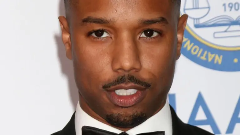 Michael B. Jordan Brings Rico Tubbs to Life in a Gray Suit and White Tie in First ‘Miami Vice’ Set Photos